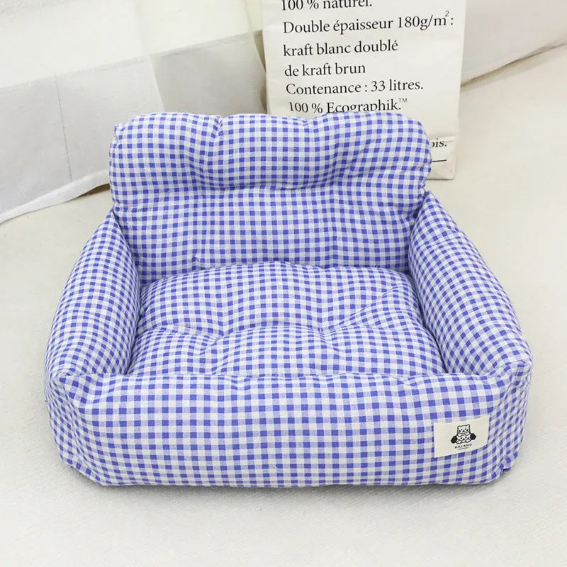 Car-mounted pet outing nest in stain-resistant cloth showing grey and blue plaid colour options