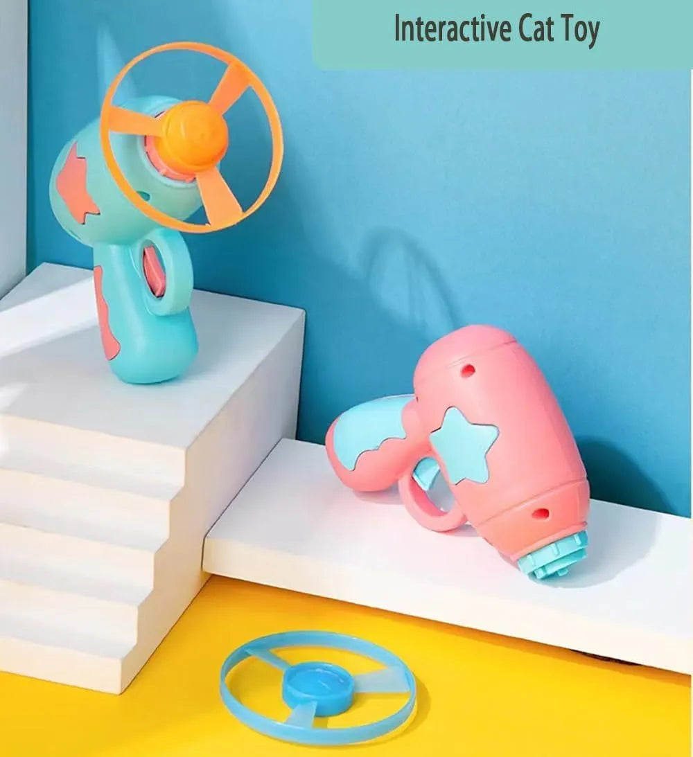 Blue or pink plastic cat toy gun with frisbee, showing compact size for indoor cat play.