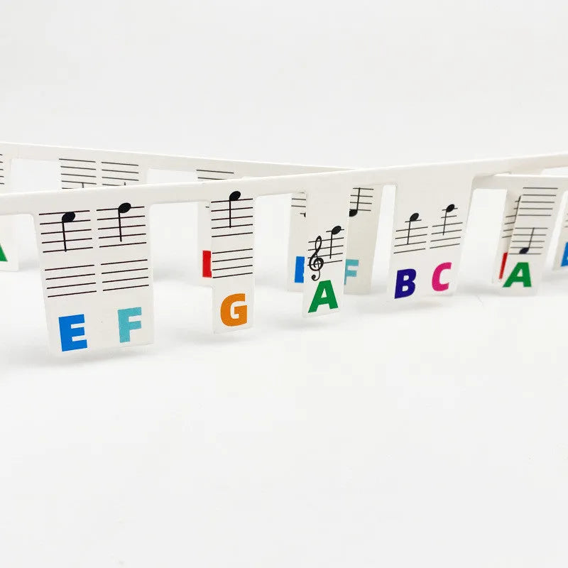 Piano keyboard stickers with colour note bars and black notes for 88-key learning on white card