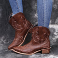 Women's blue embroidered cowboy boots with low chunky heel and pointed toe.