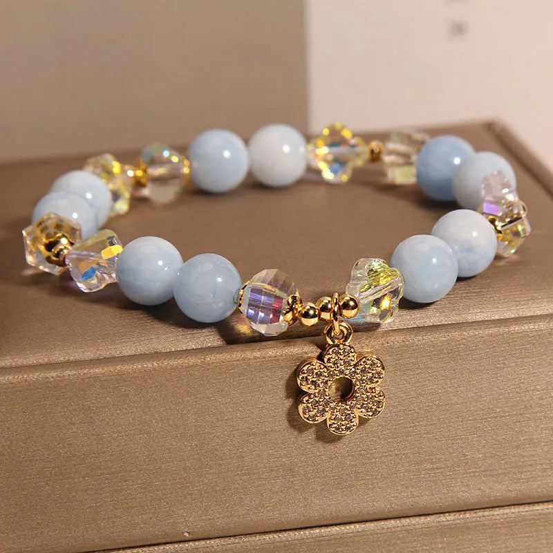 Women's aquamarine crystal bracelet with four-leaf clover charm and pearl accents in light luxury design