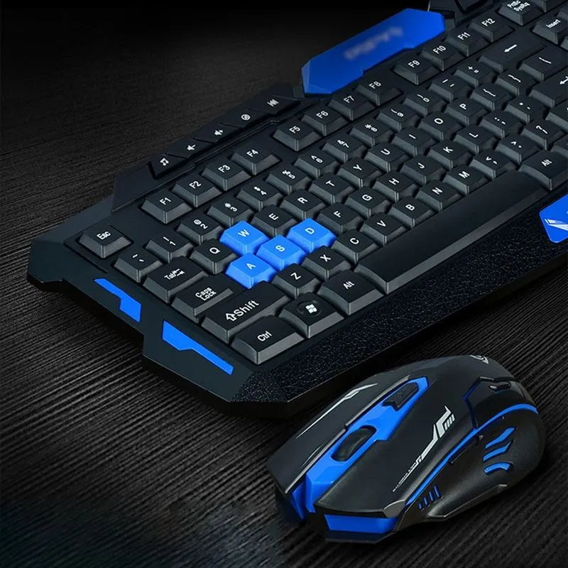 Black and blue wireless keyboard and mouse set with USB receiver on a desk.