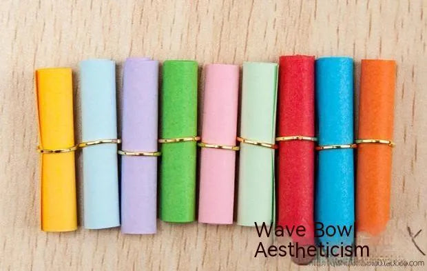 Assorted colourful mini paper scrolls with central metal eyelets for drift bottle messages.