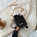 Small black women's messenger bag with chain strap and bucket shape showing pull cord opening