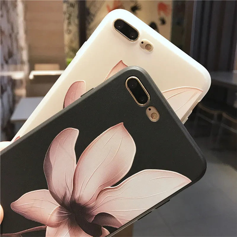 Black TPU iPhone case with a raised white embossed floral pattern on the back.