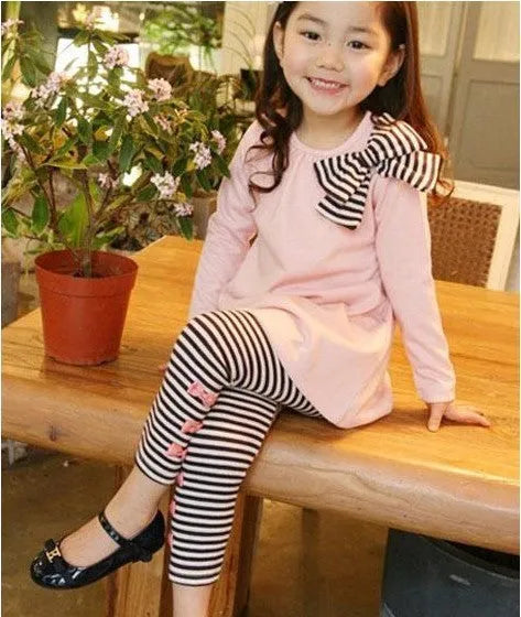 Pink cotton two-piece clothing set for a young girl, showing top and bottom.