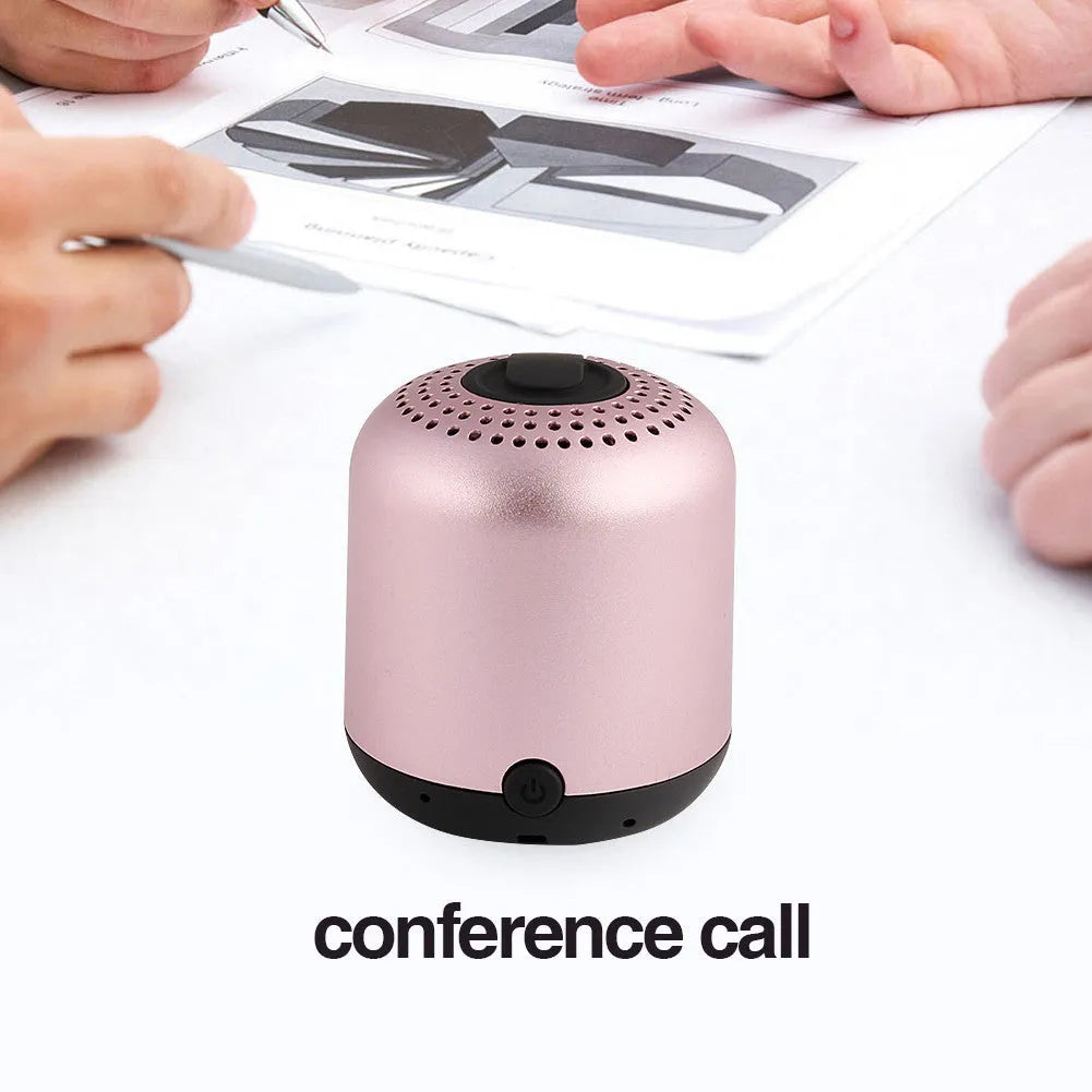 Hieha XQ11 cylindrical mini portable Bluetooth speaker in silver colour on a table.
