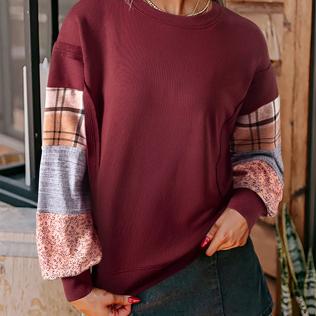 Women's beige and red plaid long-sleeved loose-fit polyester top on a hanger.