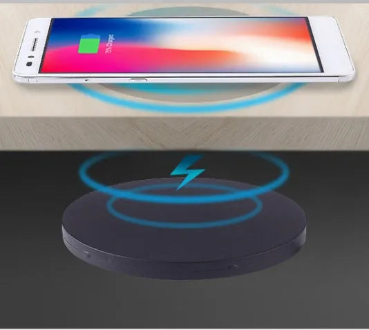 Round embedded wireless phone charger for installation in desks and furniture, shown with USB port.