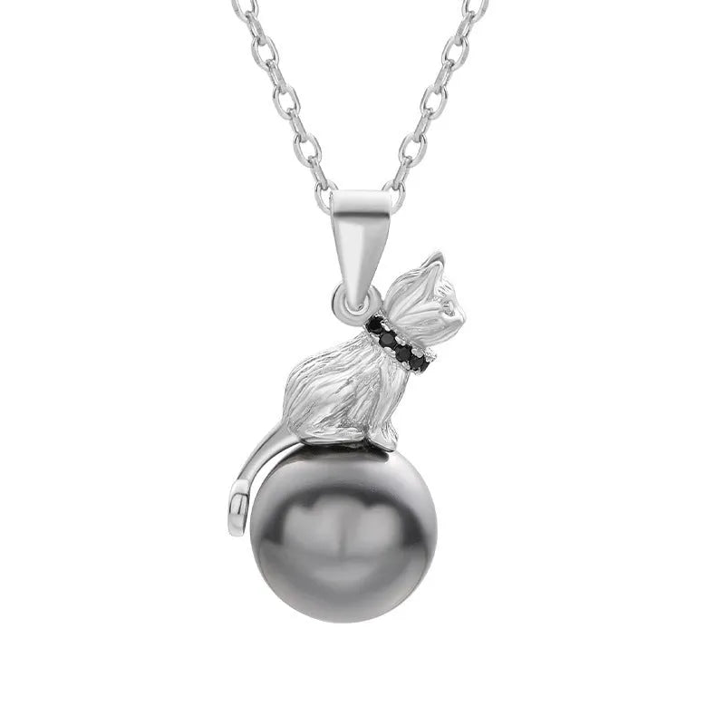 Close-up of a sterling silver cat pendant on a clavicle chain, showing detailed feline design and bright electroplated finish.