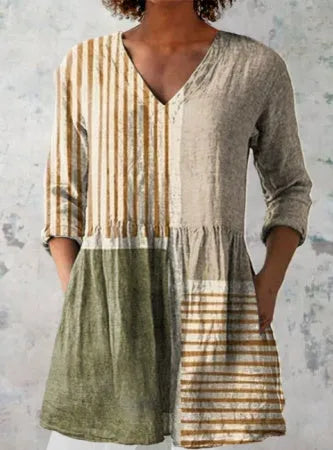 Women's loose-fit dress with a blue and white wave print, wide waist, and 3/4 length sleeves.