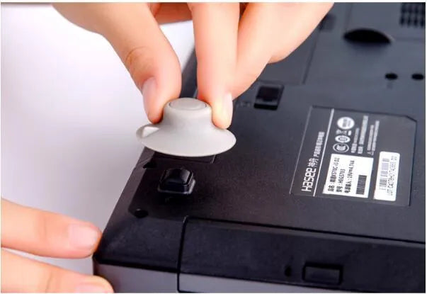 Grey plastic laptop cooling pad set showing two larger and two smaller pads for temperature reduction