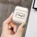 Transparent plastic protective cover for Apple AirPods case on a table.