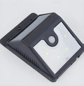 Set of four white solar security lights with motion sensors and adjustable solar panels for outdoor mounting