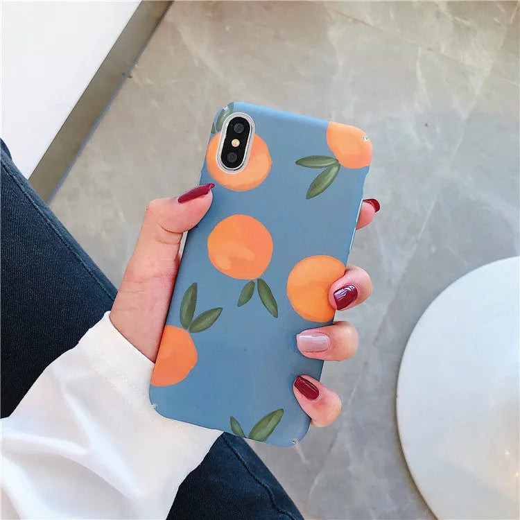 Orange retro plastic back cover phone case for iPhone on a blue and water background.