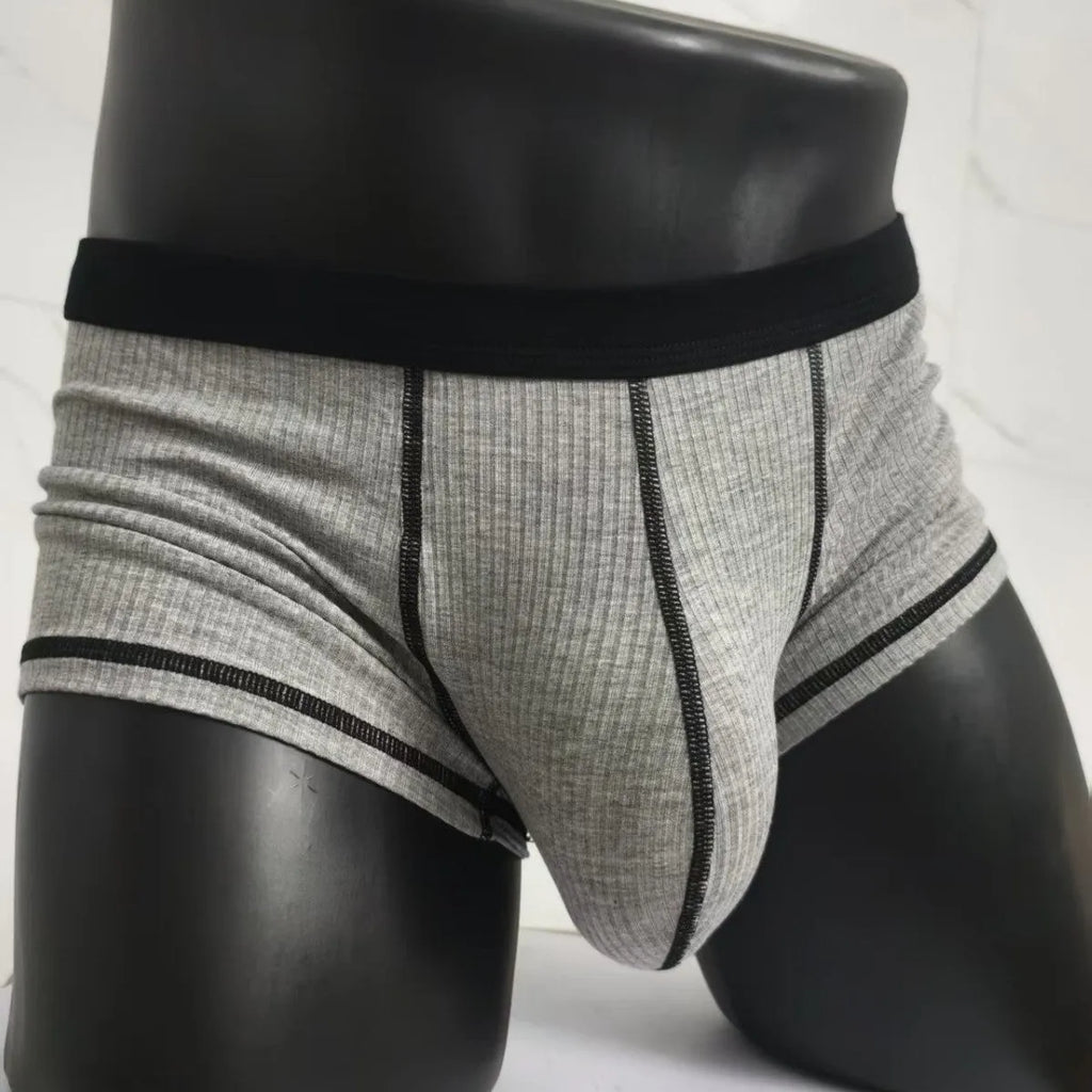Men's solid-colour fibre boxer shorts on a white background showing hip-lifting design.