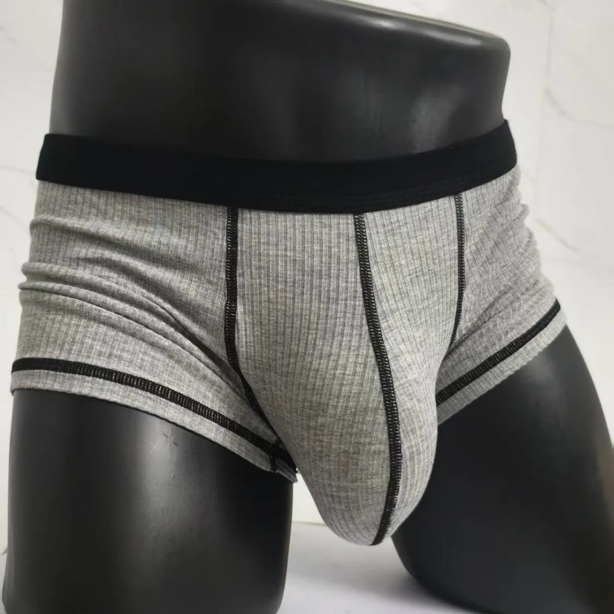 Men's solid-colour fibre boxer shorts on a white background showing hip-lifting design.