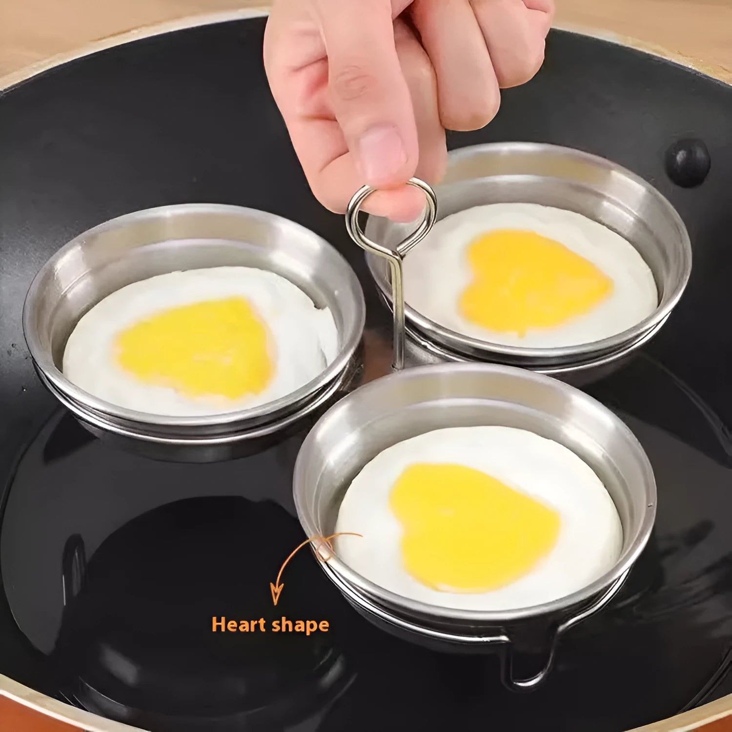 A mini stainless steel egg steamer shown in both round and heart-shaped design variations.