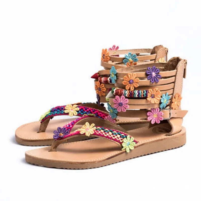 Women's ethnic beaded petal Roman sandals with round toe on a light background.