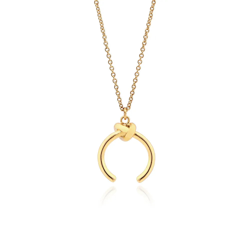 Geometric copper pendant necklace on an adjustable cross chain in gold or silver finish.