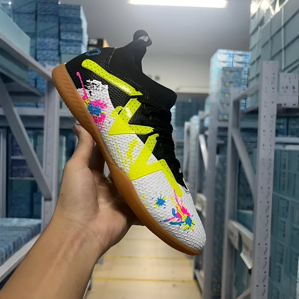 Adult football boots with non-slip rubber outsoles in black and yellow colourway