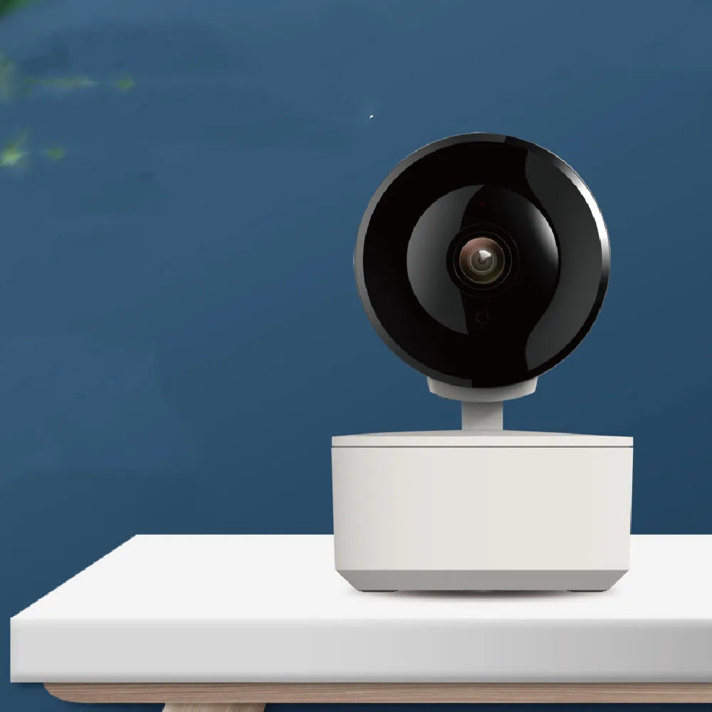 Indoor smart Wi‑Fi security camera with pan‑tilt base on a desk.