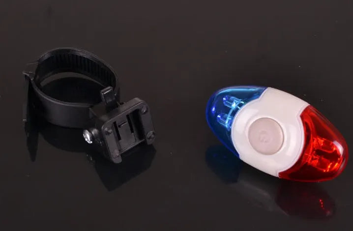 Red and blue LED tail light with adjustable mounting base shown in use.