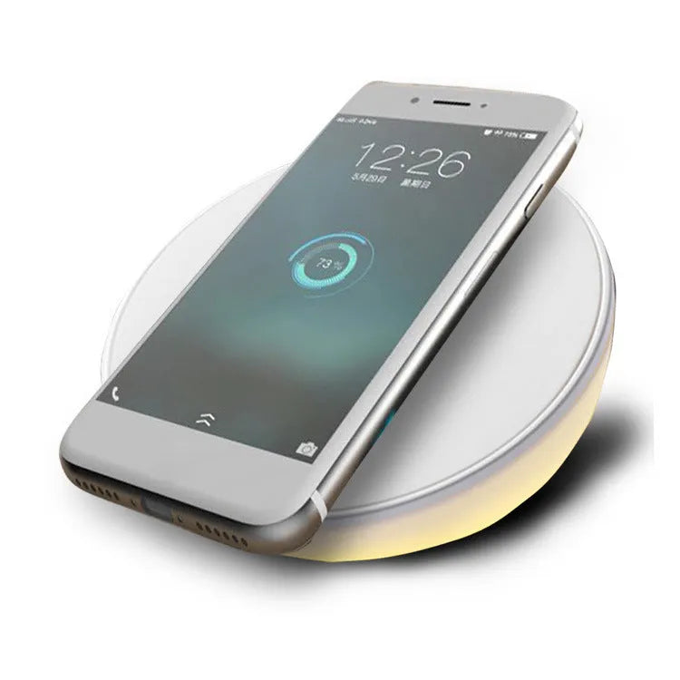 White wireless smartphone charger with digital clock display and three control buttons on the front.