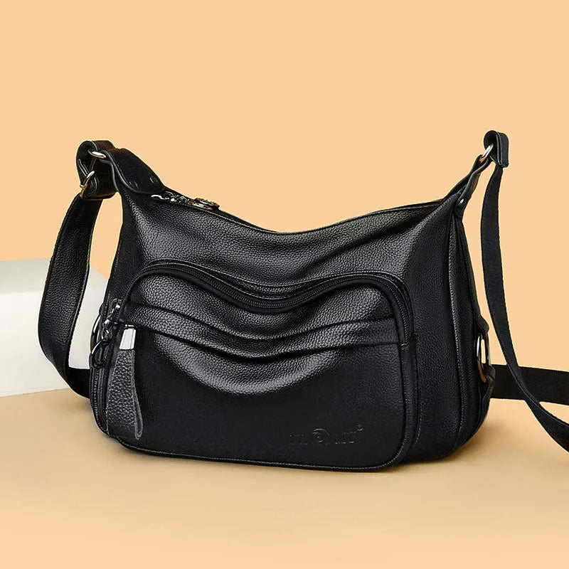 Large black women's shoulder bag with multiple internal organisation pockets and crossbody strap