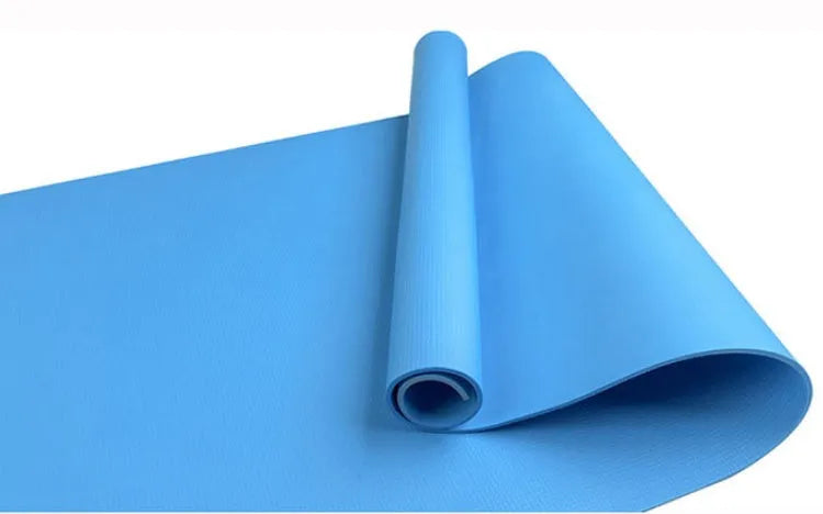 Red EVA fitness yoga mat showing texture and thickness, rolled partially with carry bag.