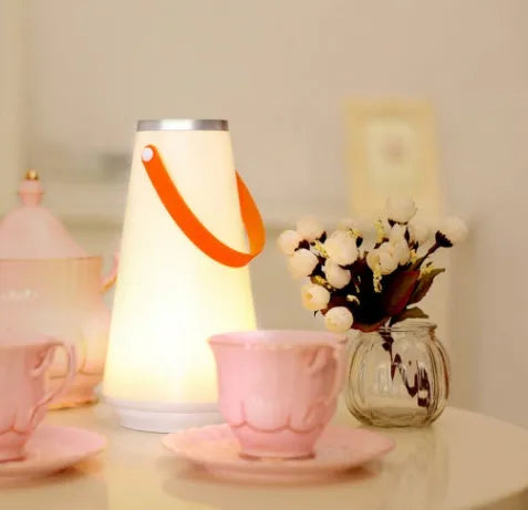 White rechargeable LED table lamp with adjustable warm light settings and USB charging cable
