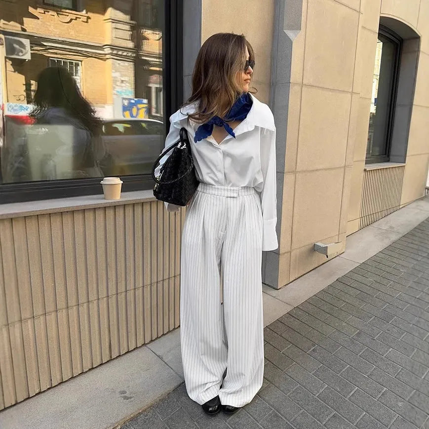 White striped wide-leg loose fit trousers with zipper front on a hanger