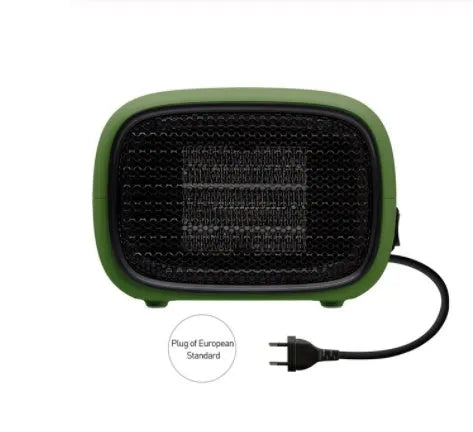 Green mini PTC ceramic heater with metal mesh front on a wooden desk