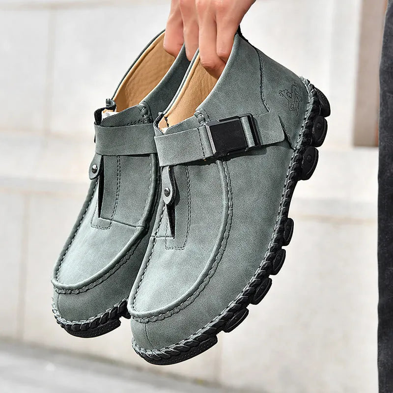 Casual flat slip-on shoe with handmade stitching on a brown PU leather upper.