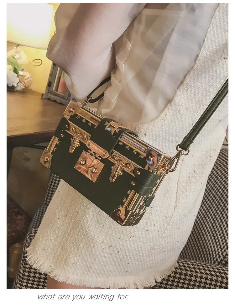 Hard-sided black PU leather women's shoulder bag with flap and decorative rivets.