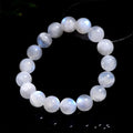 Natural white moonstone round bead bracelet showing blue moonlight sheen and polished surface