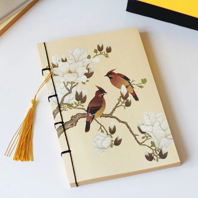 A5 antique wire-bound notebook with retro painting cover, thread binding, and black tassels.