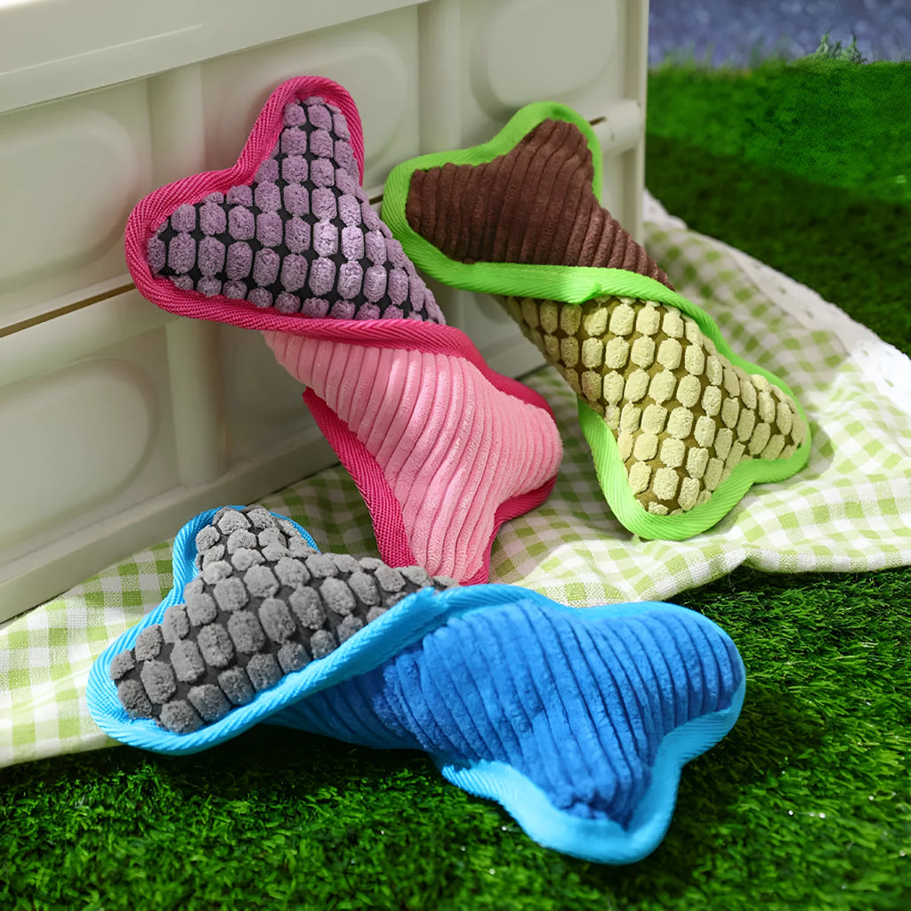 Blue plush teddy dog toy with a bone shape, designed for small to medium breeds with squeaker and crackling paper inside.