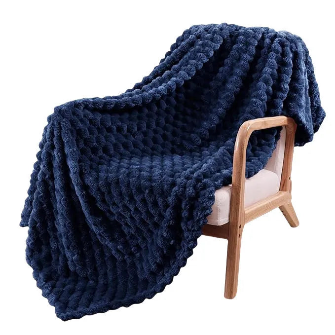 Children's soft plaid polyester blanket in camel colour on a bed