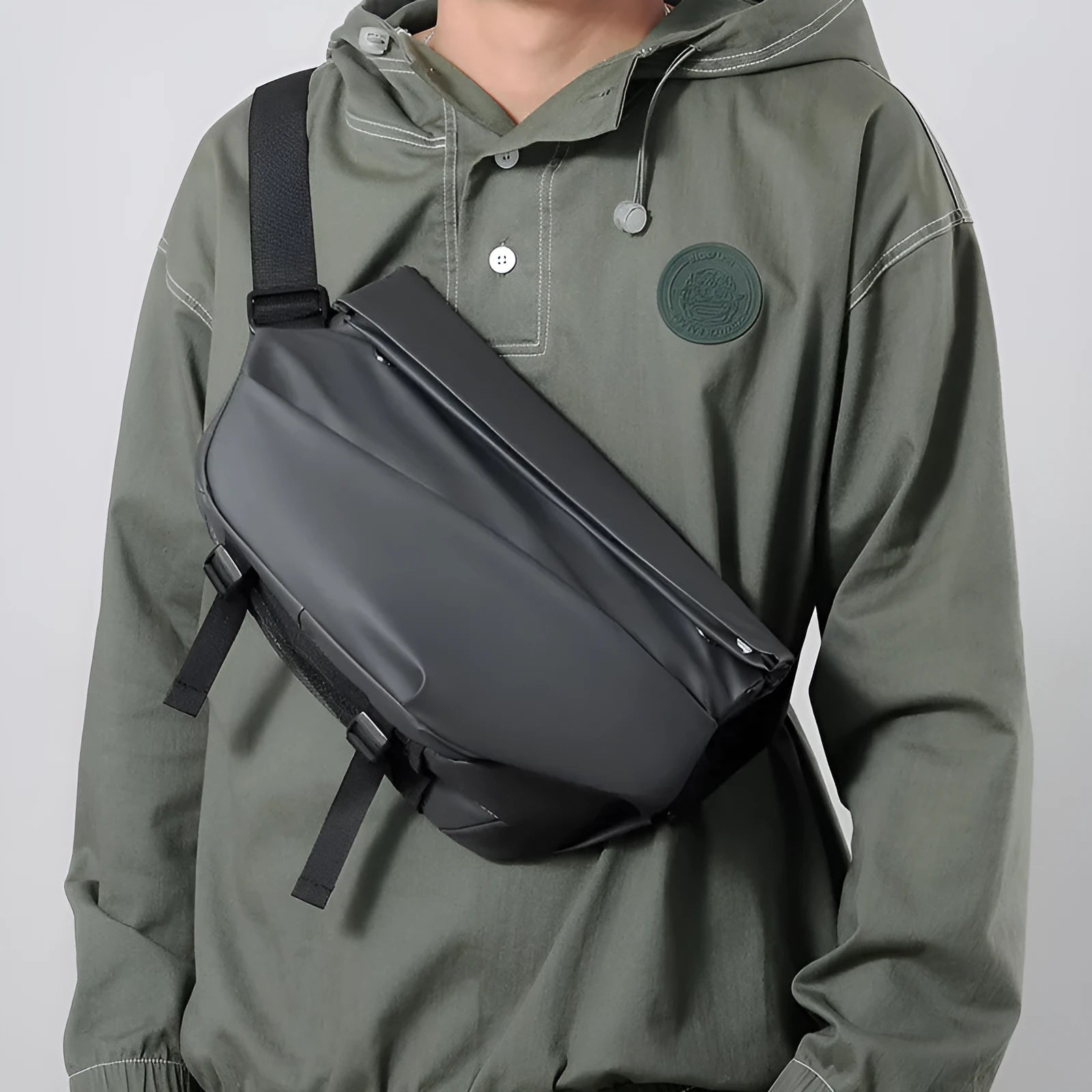 Grey PU men's crossbody sling backpack with a phone pocket on a mannequin.