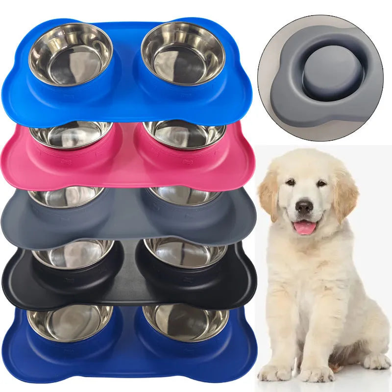 Large black silicone dog bowl sitting inside a stainless steel base, shown on a kitchen floor.