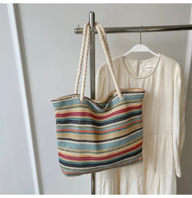 Blue straw-woven nylon shoulder bag with a single strap and large main compartment.