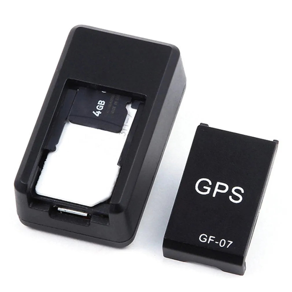 Small black magnetic GPS tracker device for cars with a USB charging cable.