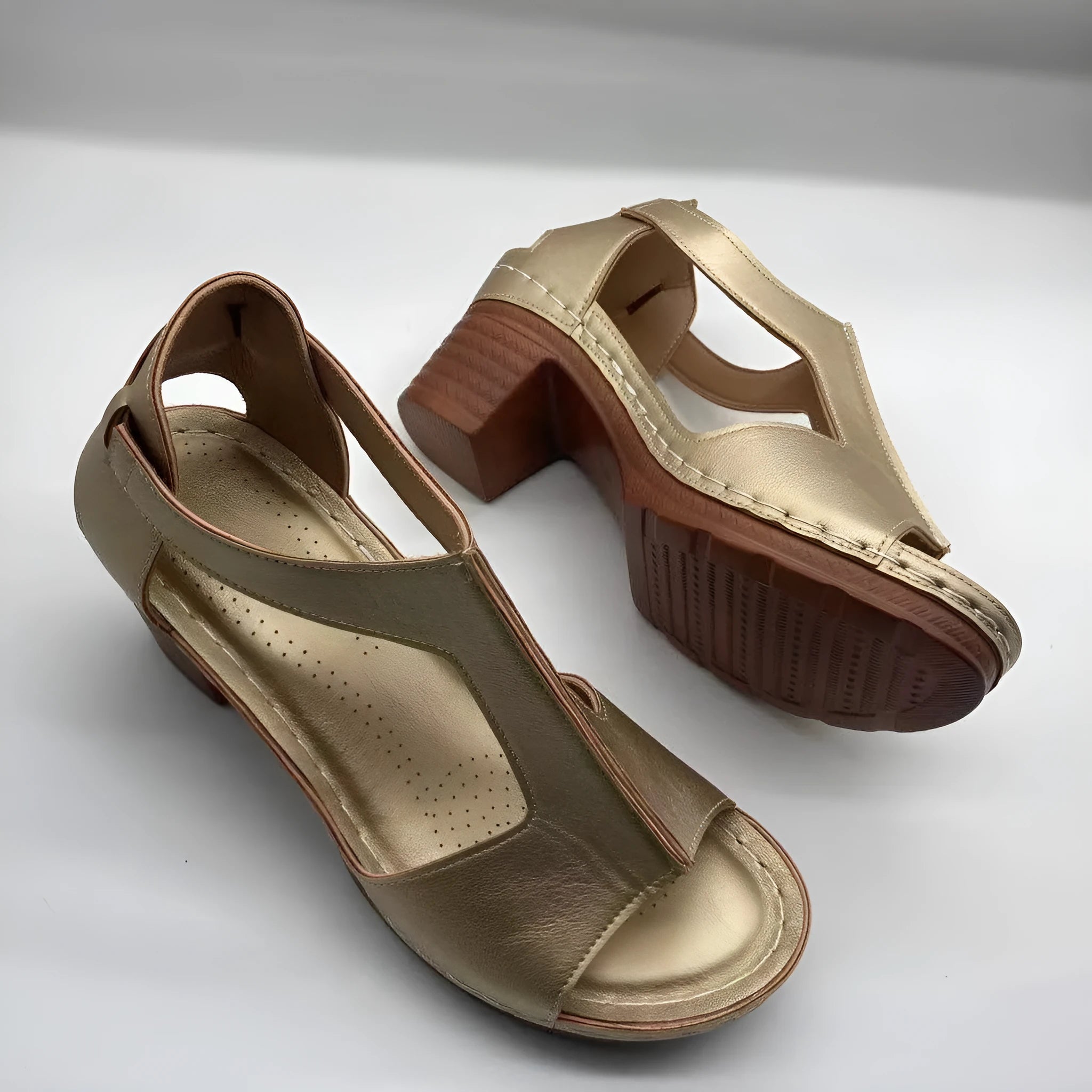 Women's beige peep toe wedge sandals with a Roman-style buckle strap on a low heel.