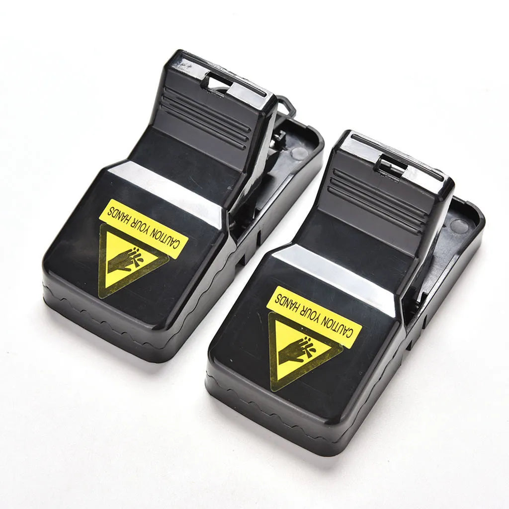 Six black plastic snapping mousetraps showing 11cm length and biting mechanism