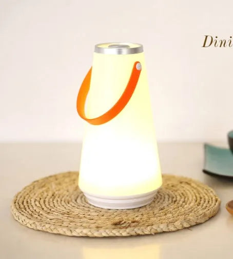 White rechargeable LED table lamp with adjustable warm light settings and USB charging cable