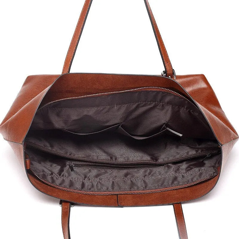 Genuine cowhide leather cross-body handbag showing two compartments and available in five colours