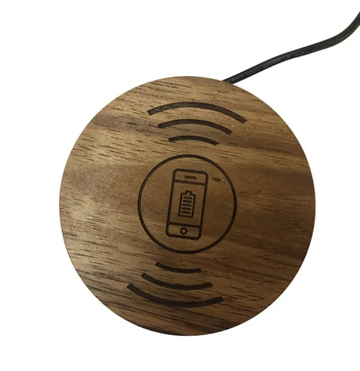 Round embedded wireless phone charger for installation in desks and furniture, shown with USB port.