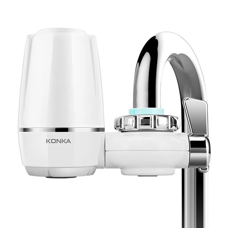 White plastic faucet water filter with adapter kit and ceramic cartridge for kitchen tap installation.