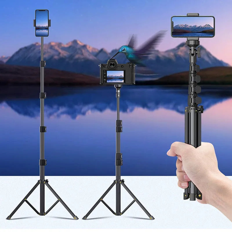 Black aluminium selfie stick tripod extended next to a smartphone, showing its 5-section telescopic shaft.